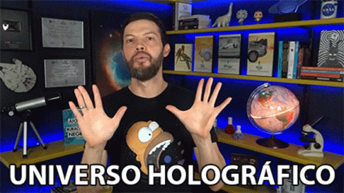 Man In Front Of Shelf Saying Universo Holographico GIF