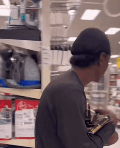 Man in Front of Shelf With LG Sign