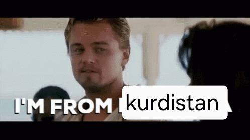 Man in Front of Sign Saying I'm From Kurdistan