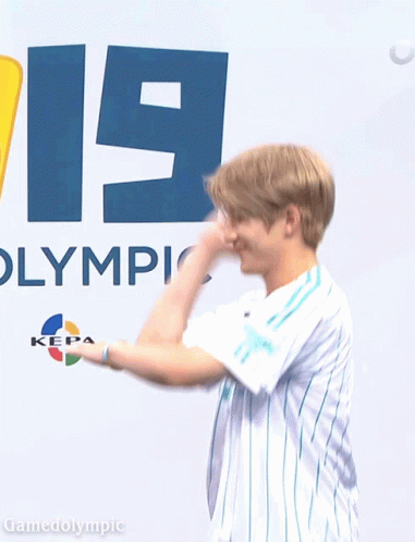 Man in Front of Sign Saying Olympic