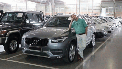 Man In Front Of Silver Volvo Car GIF