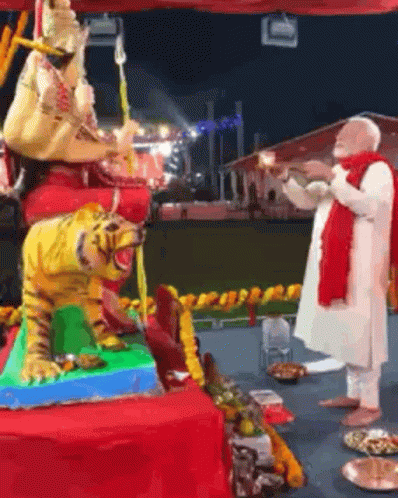 Man in Front of Tiger and Woman Statues