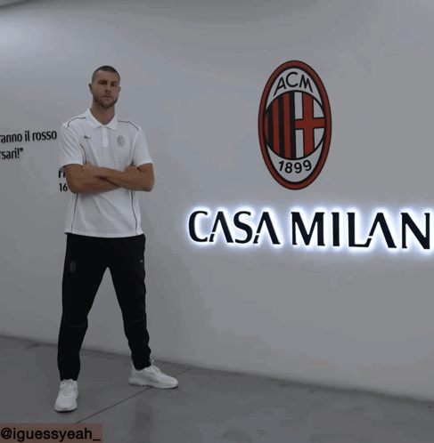 Man In Front Of Wall With ACM Logo GIF