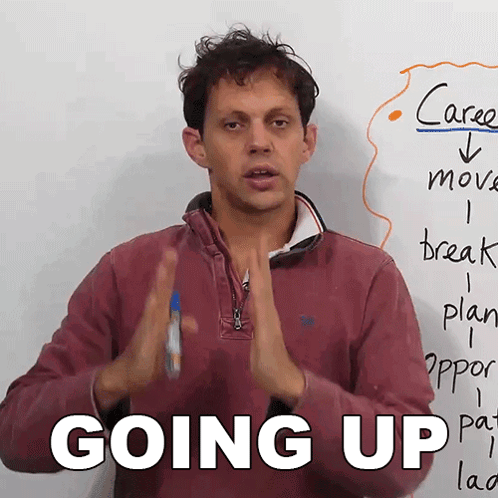 Man in Front of White Board Saying Going Up
