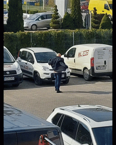 Man In Front Of White Van Saying Elbo GIF