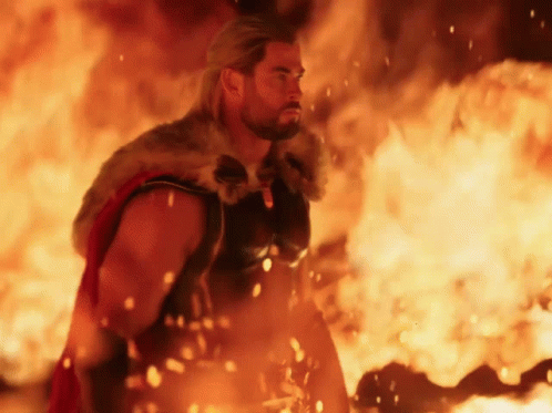 Man in Fur Cape Standing in Front of Fire