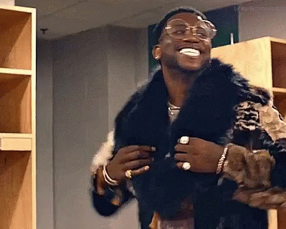 Man in Fur Coat and Glasses Laughing