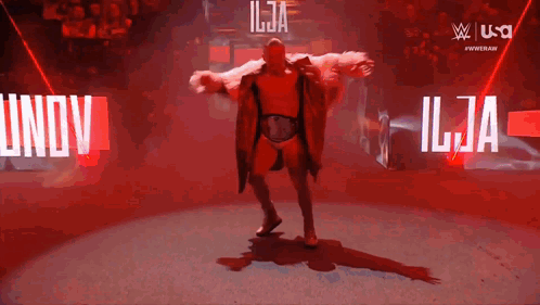 Man in Fur Coat Dancing in Front of Ilja Sign
