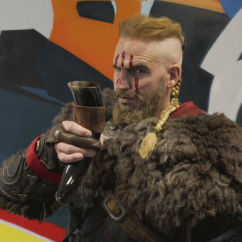 Man In Fur Coat Holding Horn GIF
