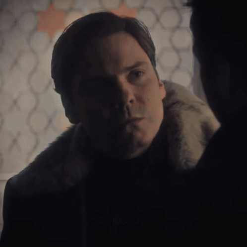 Man In Fur Coat Looking At Another Man GIF