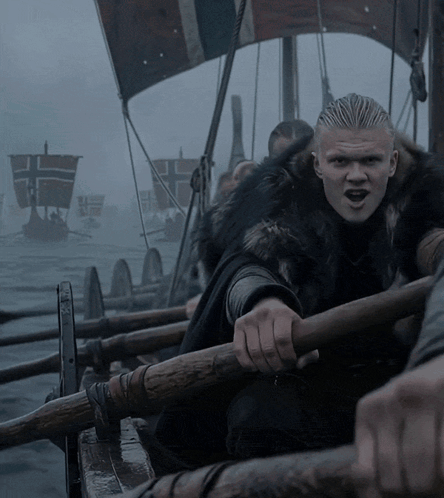 Man in Fur Coat Rowing Boat