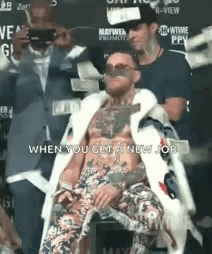 Man In Fur Coat Sitting With Money GIF