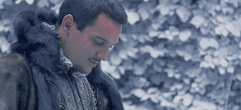 Man in Fur Coat Standing in Snow With Eyes Closed