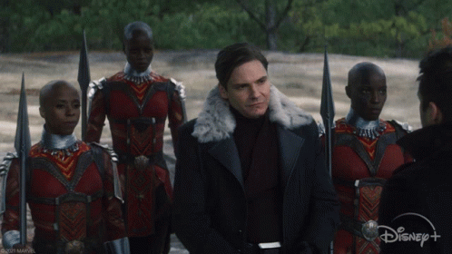 Man in Fur Coat Stands Before Crowd With Disney+