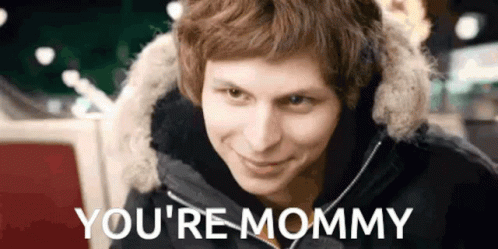 Man in Fur Hood Smiling Saying You're Mommy