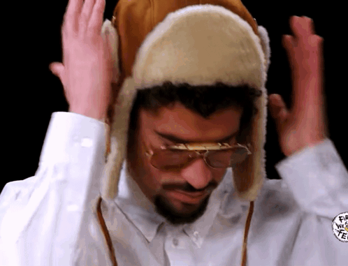 Man in Furry Hat and Glasses Making Funny Face