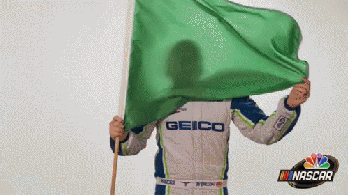 Man in Geico Uniform Holding Green Flag