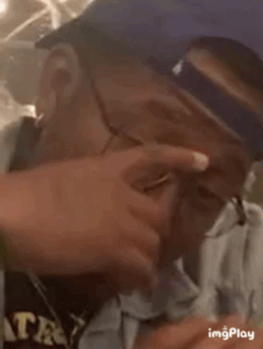 Man in Glasses and Baseball Cap Looking Down