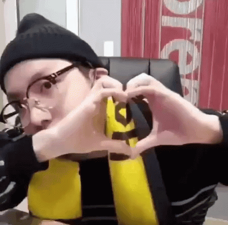 Man in Glasses and Beanie Making Heart
