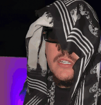 Man in Glasses and Black and White Head Scarf