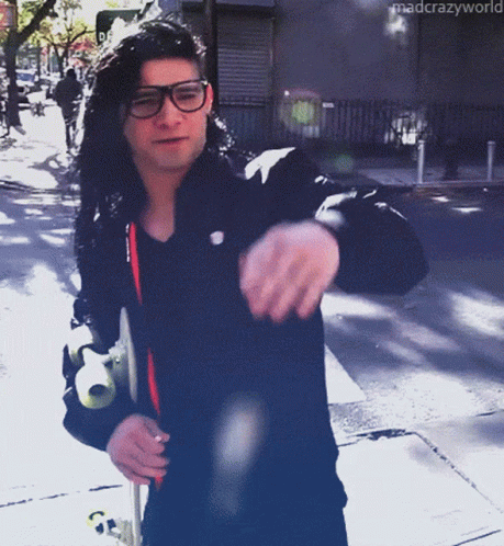 Man In Glasses And Black Jacket Walking Down Street Mad Crazy World GIF