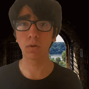 Man in Glasses and Black Shirt at Doorway