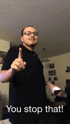 Man In Glasses And Black Shirt Holding Remote Saying You Stop That GIF