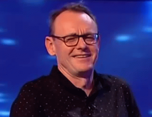Man In Glasses And Black Shirt Laughing GIF