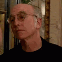 Man in Glasses and Black Shirt Looking at Camera