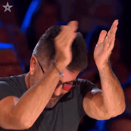 Man In Glasses And Black Shirt Raising Hands GIF