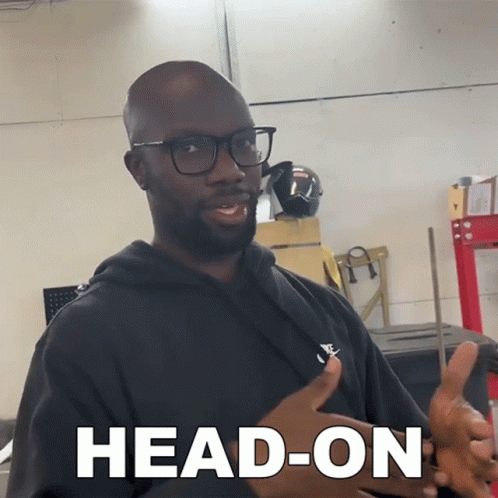 Man in Glasses and Black Shirt Saying Head-On