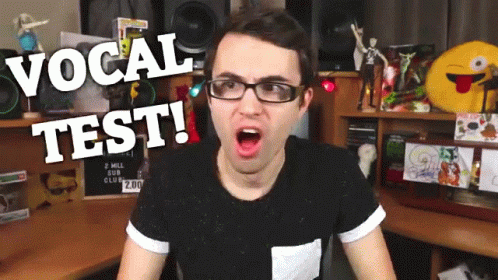 Man in Glasses and Black Shirt Vocal Test