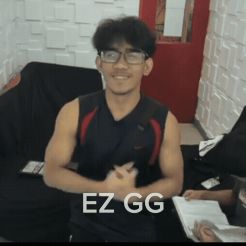 Man in Glasses and Black Tank Top Saying EZ GG