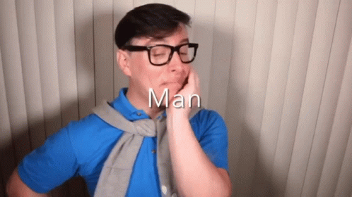 Man in Glasses and Blue Shirt With Word Man Above