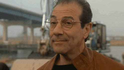 Man in Glasses and Brown Jacket Smiling
