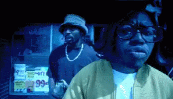 Man in Glasses and Bucket Hat at 99 Cents Sign
