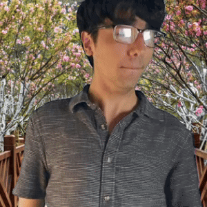 Man in Glasses and Grey Shirt by Cherry Blossom