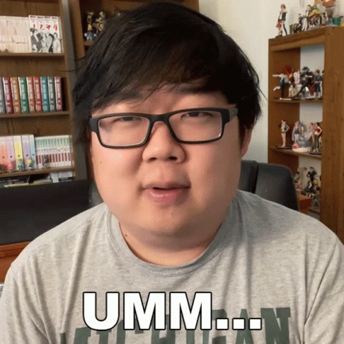 Man in Glasses and Grey Shirt Saying Umm