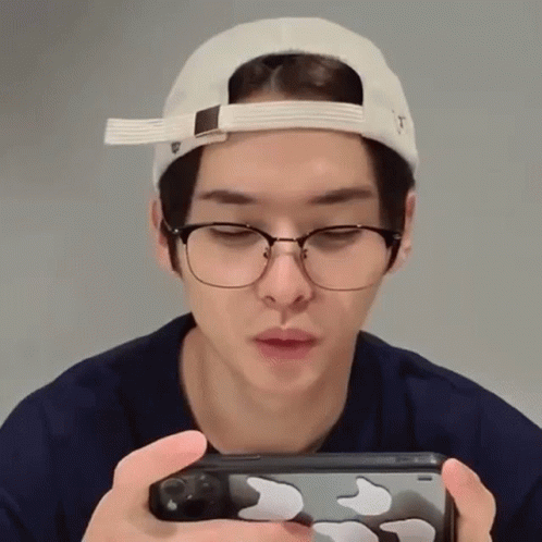 Man In Glasses And Hat Holding Cell Phone GIF
