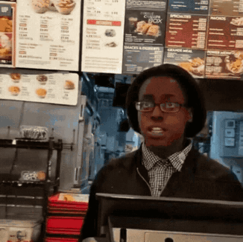 Man in Glasses and Hat in Front of Chicken Box Menu