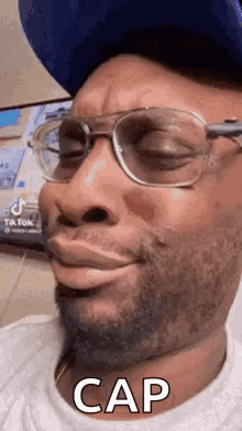 Man In Glasses And Hat Making Funny Face Saying Cap GIF