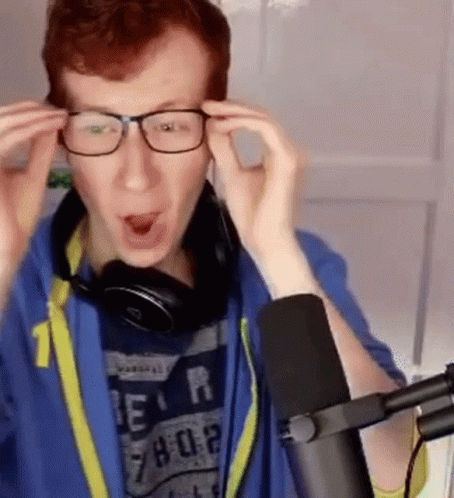 Man in Glasses and Headphones at Microphone