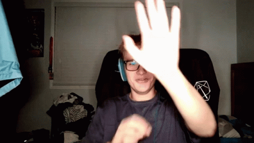 Man In Glasses And Headphones Raises Hand GIF