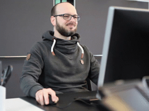 Man in Glasses and Hoodie at Computer
