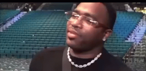 Man in Glasses and Necklace at Stadium