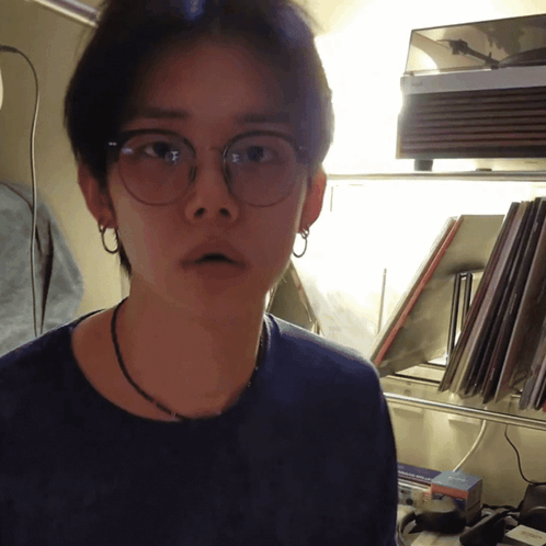Man in Glasses and Necklace by Record Player
