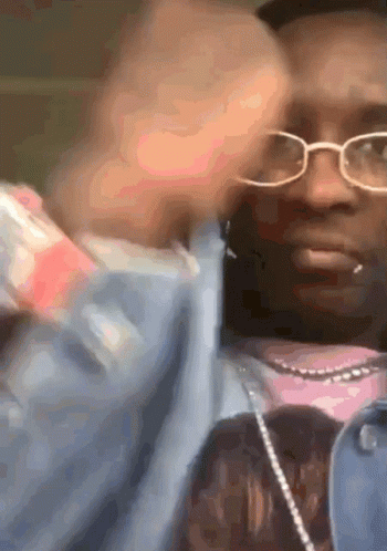 Man In Glasses And Pink Shirt Holding Bottle GIF