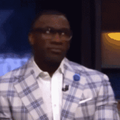 Man in Glasses and Plaid Jacket With Blue Pin
