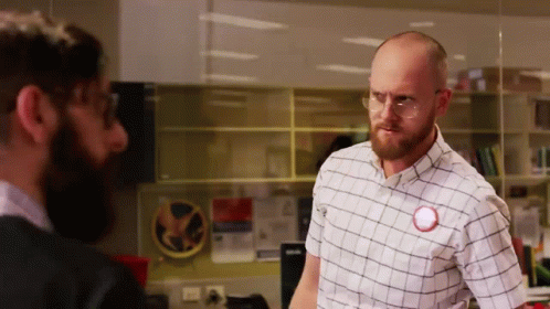 Man in Glasses and Plaid Shirt With Red Circle on Shirt