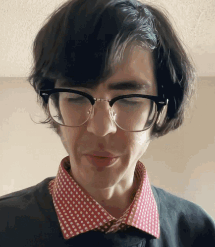 Man in Glasses and Polka Dot Shirt Looking Down